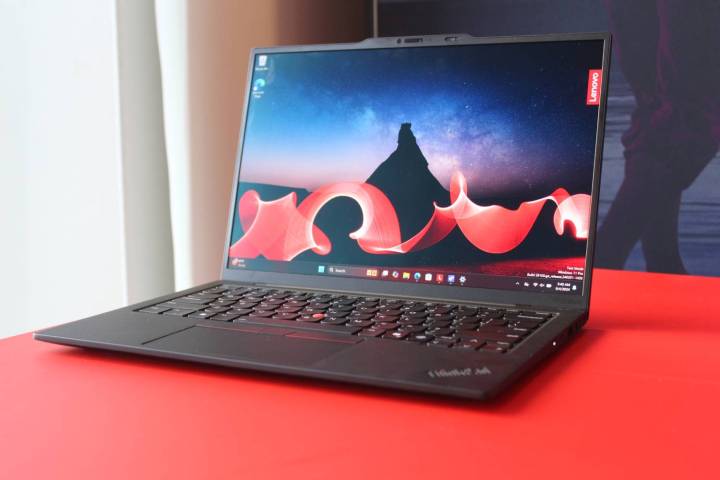 The ThinkPad X1 Carbon Gen 13 on a red table.